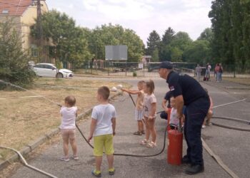 Hasiči s deťmi pri rýchlom cvičení s vodou a tzv. brentačmi